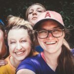 A joyful group of women taking a selfie outdoors, showcasing happiness and friendship.
